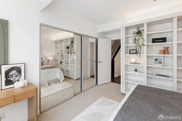 a bedroom with furniture and a window