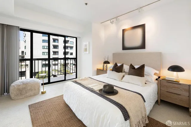 a bedroom with a bed and a large window