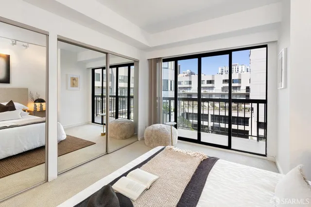 a bedroom with a bed and glass walk in closet