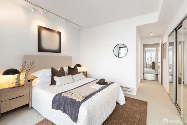 a bedroom with a bed and a lamp