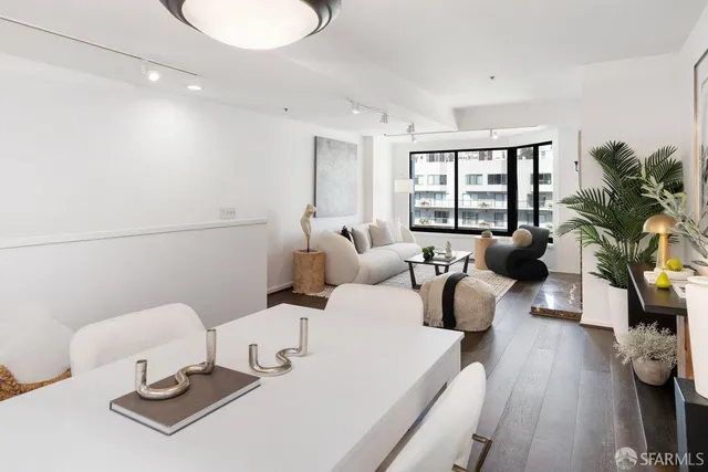 a living room with furniture potted plant and a table