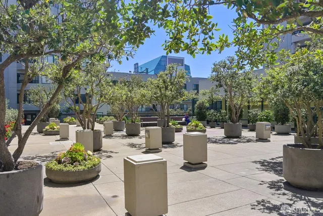 a view of a building with garden and sitting area