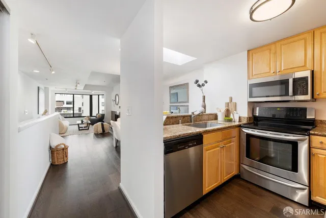 a kitchen with sink cabinets and appliances