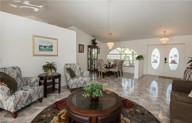 a living room with furniture and a chandelier