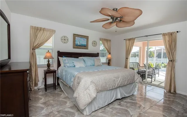 a bedroom with a bed and a large window