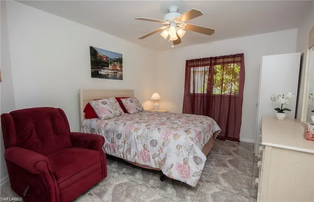 a bedroom with furniture and a window