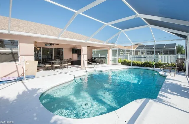 a view of a swimming pool with sitting area