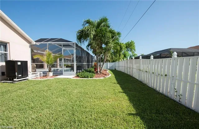 a view of a house with backyard and porch