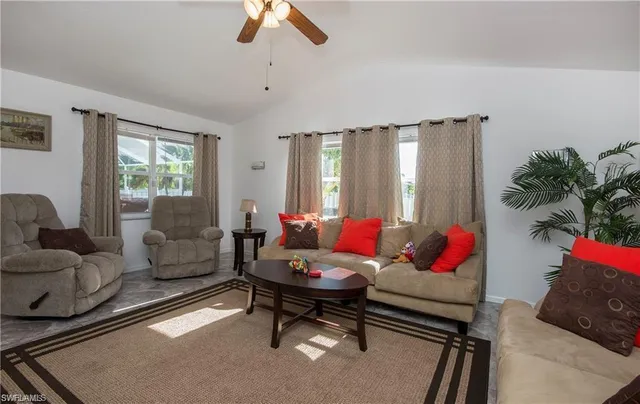 a living room with furniture and a potted plant