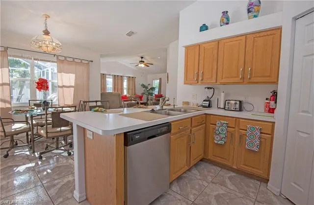 a kitchen that has a sink and a stove in it