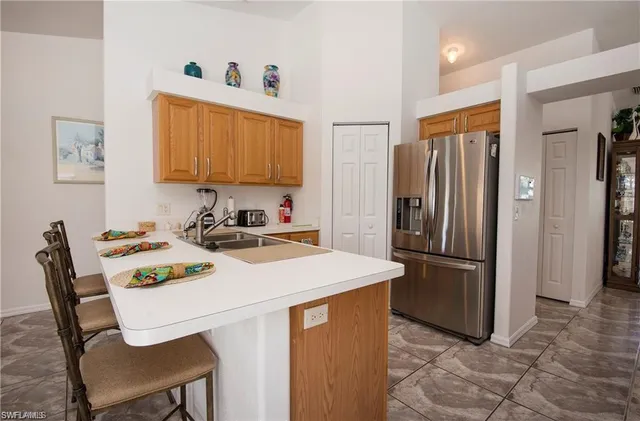 a kitchen with stainless steel appliances a stove a refrigerator and a table