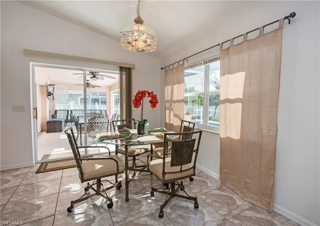 a view of a dining room with furniture wooden floor and chandelier