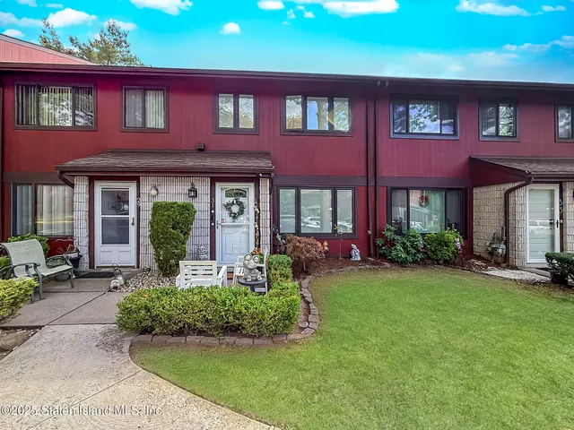 a front view of brick house with a yard