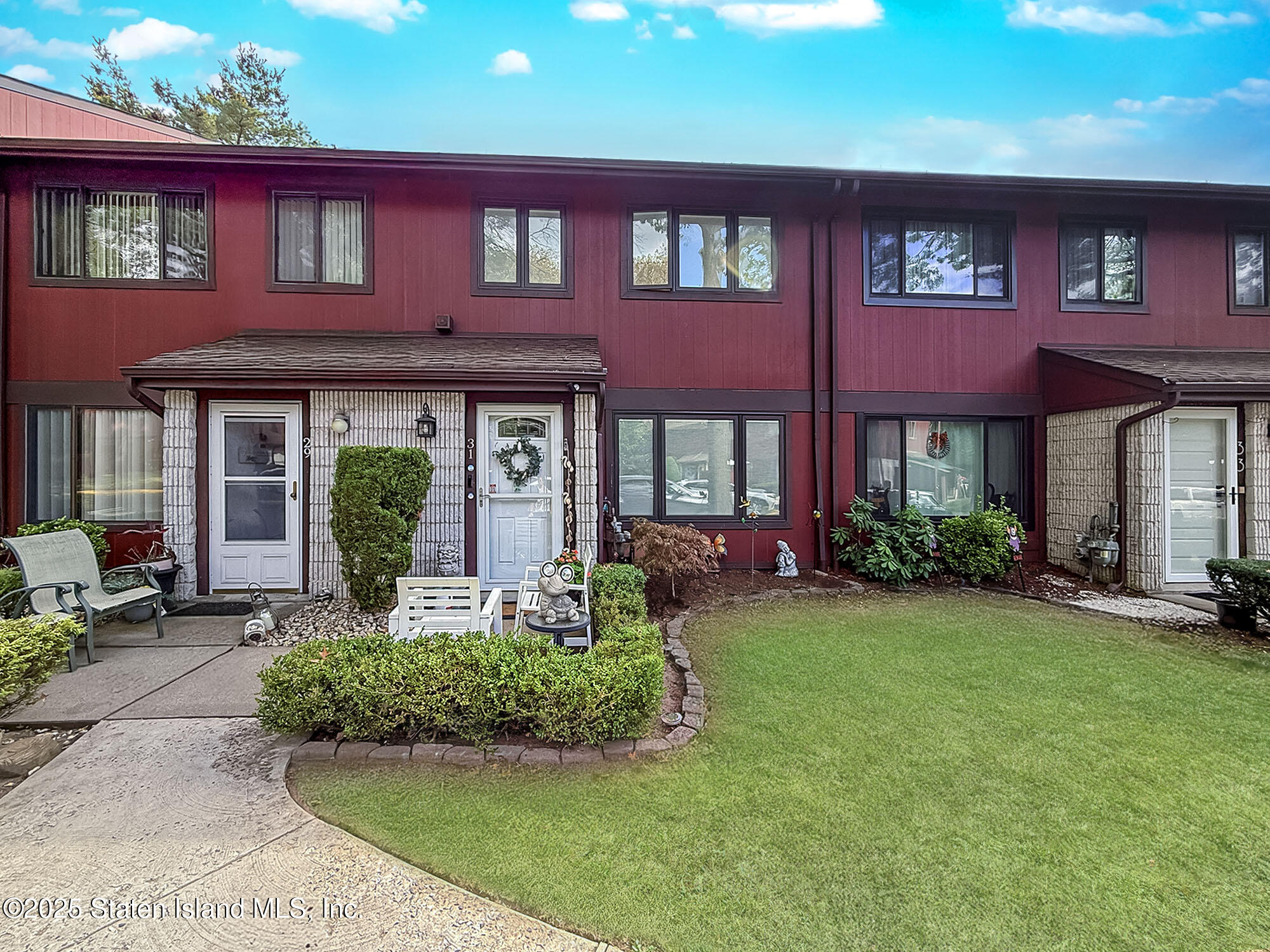 a front view of brick house with a yard