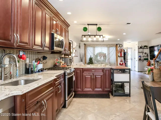 a kitchen with stainless steel appliances granite countertop a sink and cabinets