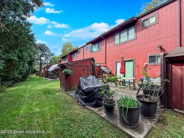 a view of a house with backyard sitting area and garden