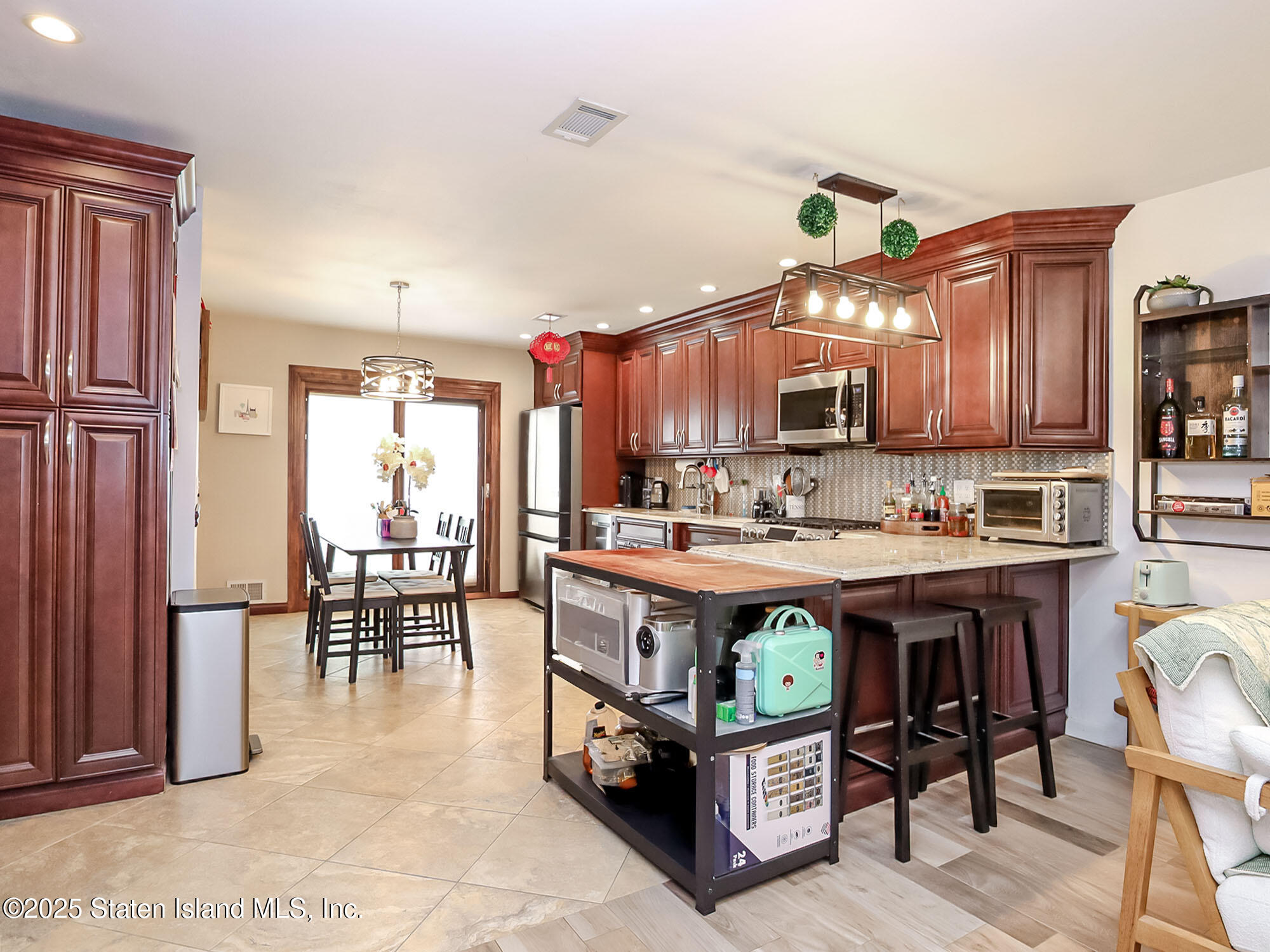 31 Pierpont Place Staten Island, NY 10314 - Photo 3 of 23 a large kitchen with lots of wooden furniture and stainless steel appliances
