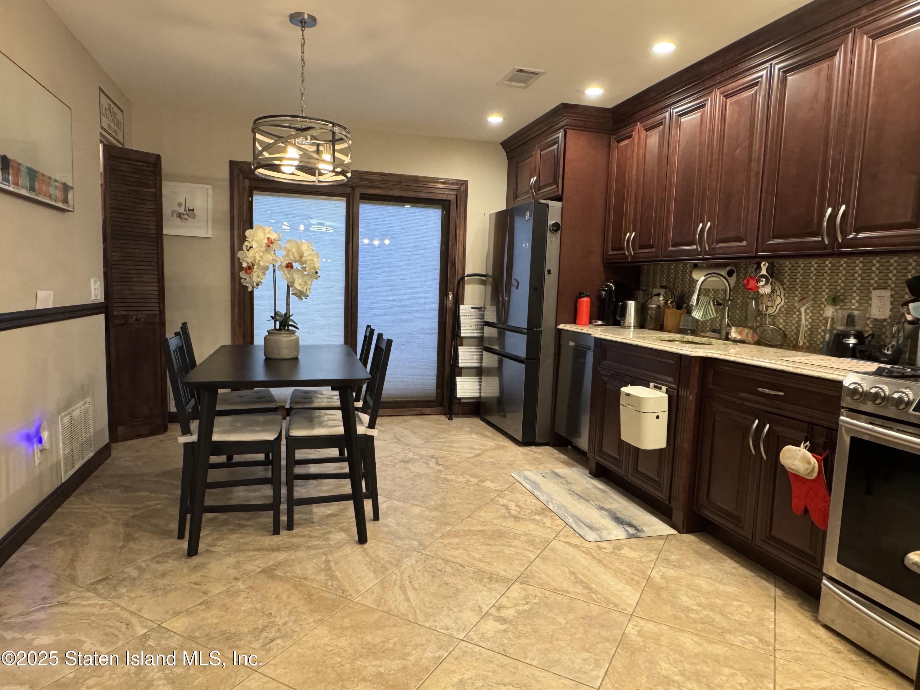 31 Pierpont Place Staten Island, NY 10314 - Photo 4 of 23 a kitchen with stainless steel appliances granite countertop a refrigerator and a stove top oven
