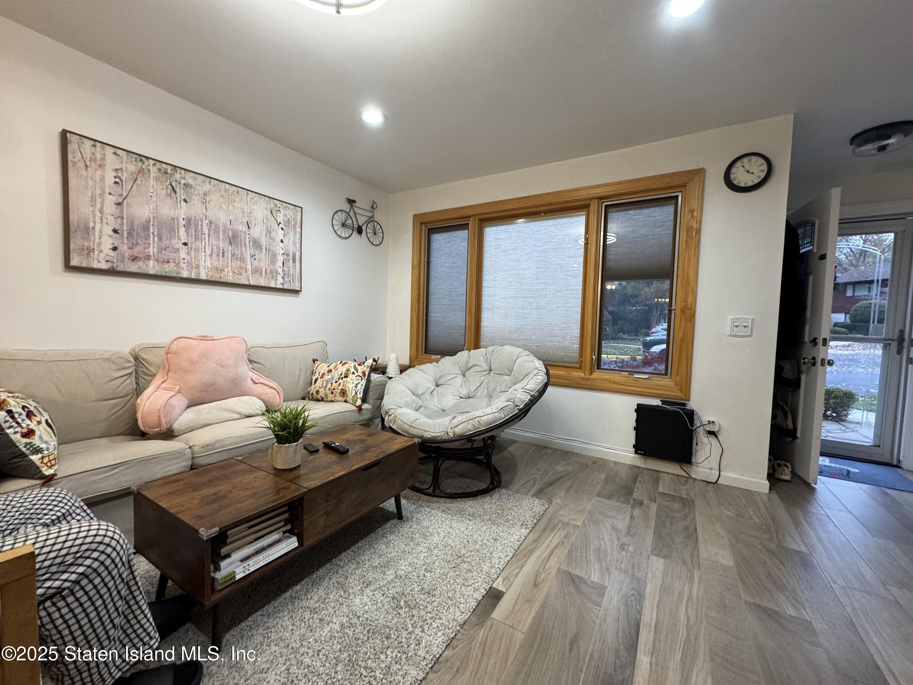 31 Pierpont Place Staten Island, NY 10314 - Photo 6 of 23 a living room with furniture and a large window