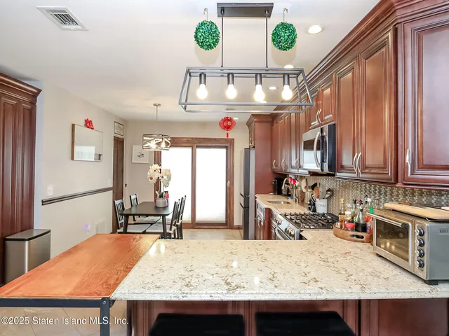 a kitchen with a stove a refrigerator and a dining table