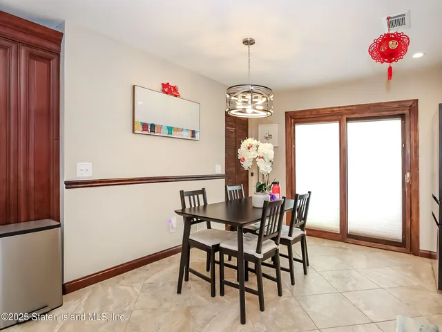 a view of a dining room with furniture and chandelier