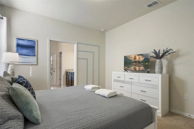a living room with furniture a rug and a chandelier