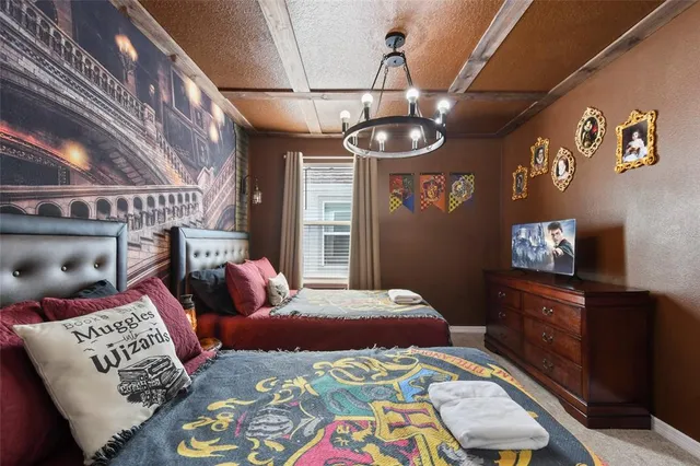 a bedroom with furniture and a flat screen tv