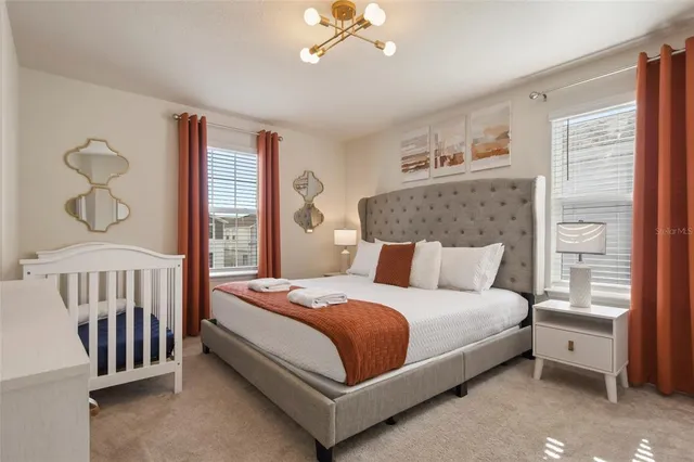 an aerial view of a house with a garden and lake view