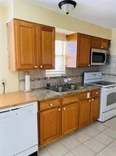 a kitchen with a sink stove and refrigerator