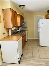 1220 Winnie Rear Street Galveston, TX 77550 - Photo 5 of 10 a kitchen with a sink stove and refrigerator