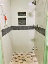 a bathroom with a granite countertop toilet and a sink