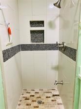 1220 Winnie Rear Street Galveston, TX 77550 - Photo 7 of 10 a bathroom with a tub and a shower