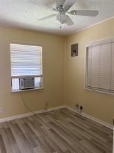 1220 Winnie Rear Street Galveston, TX 77550 - Photo 9 of 10 a view of a livingroom with wooden floor and a window