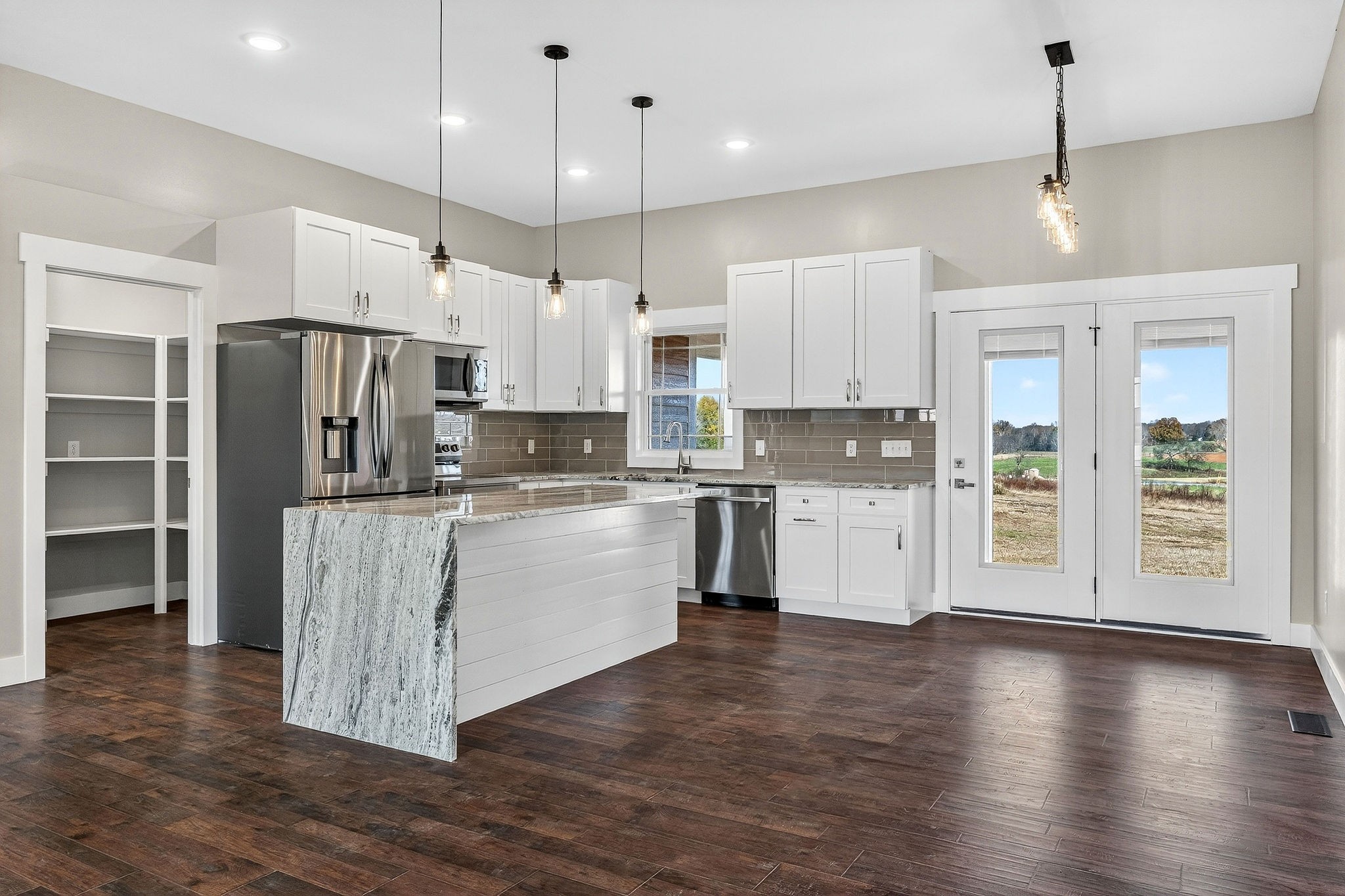 196 Dairy Barn Road Sparta, TN 38583 - Photo 12 of 44 a kitchen with kitchen island granite countertop a stove a refrigerator a sink a center island and wooden floor