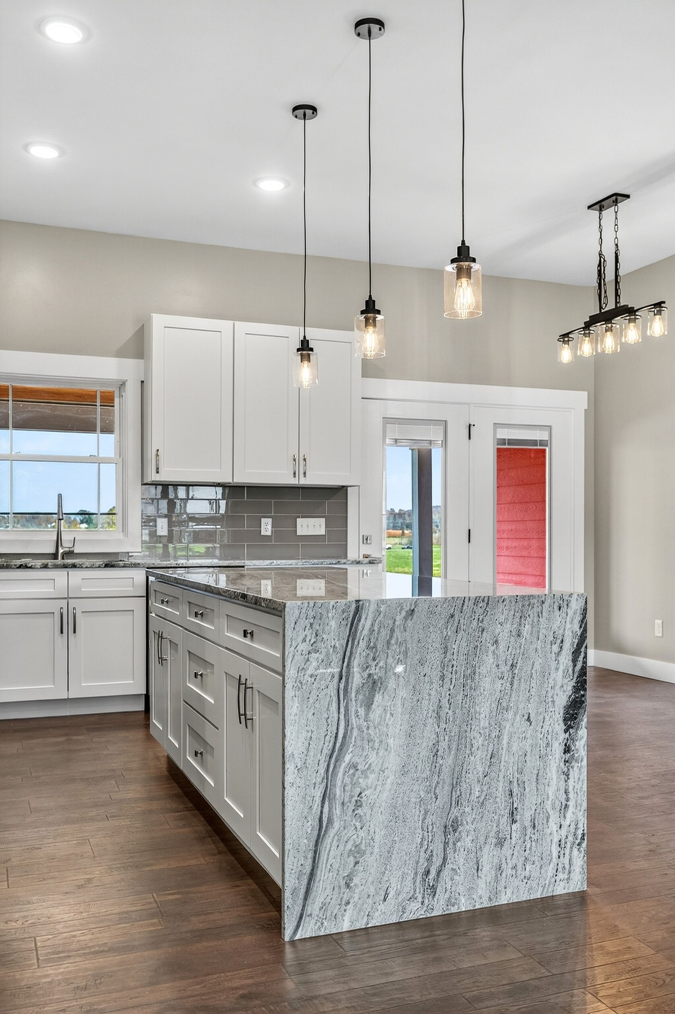 196 Dairy Barn Road Sparta, TN 38583 - Photo 15 of 44 a kitchen with stainless steel appliances granite countertop a stove a sink and white cabinets with wooden floor