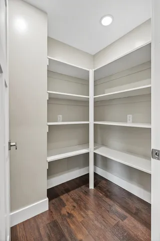 a view of a room with wooden floor and a window