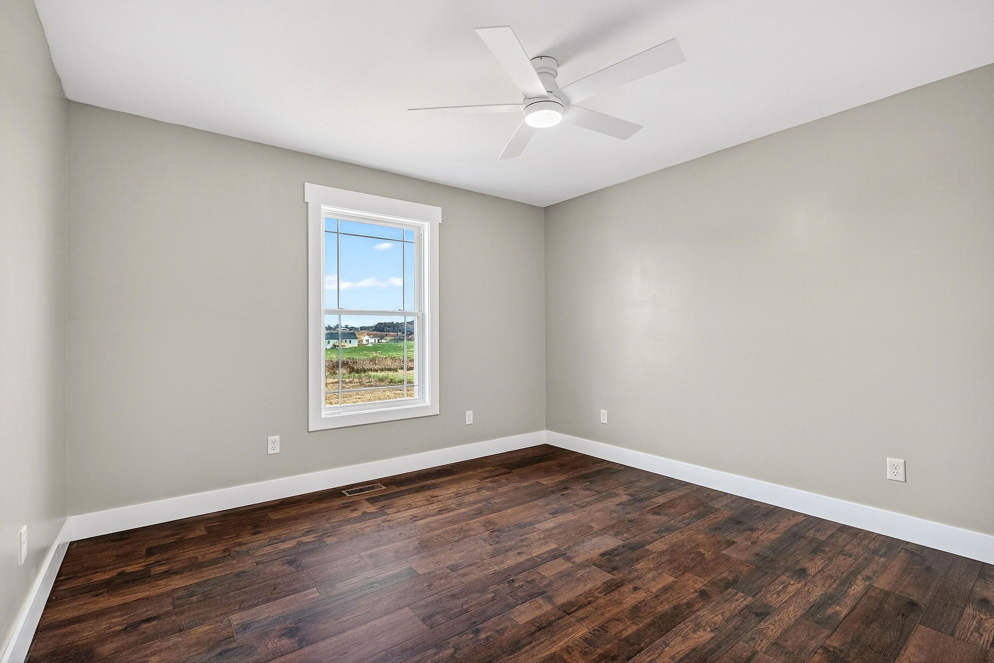 196 Dairy Barn Road Sparta, TN 38583 - Photo 28 of 44 a view of an empty room with wooden floor and a window