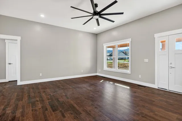 a view of room with window and wooden floor