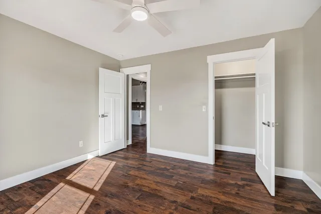 a view of an empty room with wooden floor