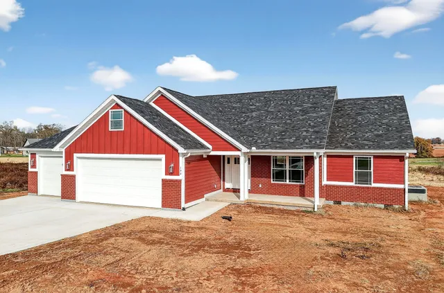 a view of a house with a backyard