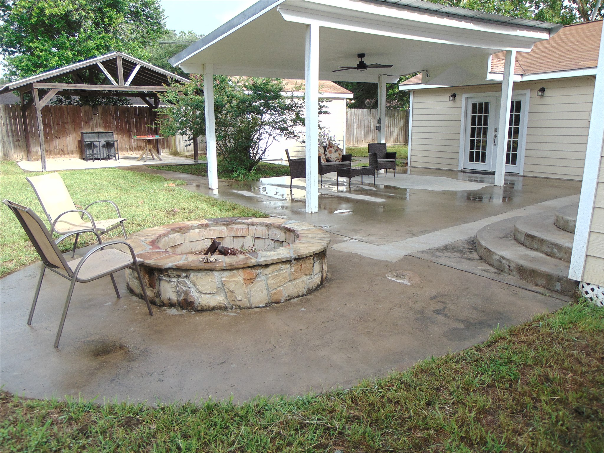 1702 Rampart Street Columbus, TX 78934 - Photo 36 of 38 Gather around the fire pit on this generously proportioned concrete patio with a covered outdoor sitting area.