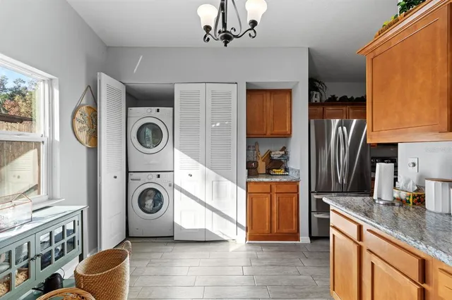 a kitchen with stainless steel appliances granite countertop a refrigerator a stove top oven a sink and dishwasher