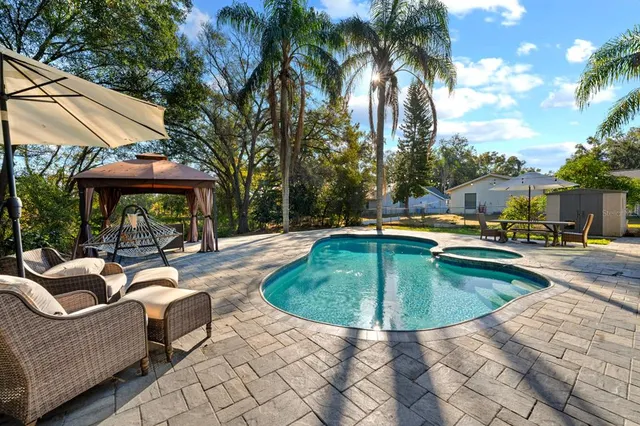 a view of a swimming pool with a patio