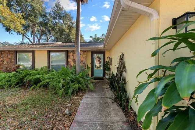 a view of a pathway with a flower in front of a house
