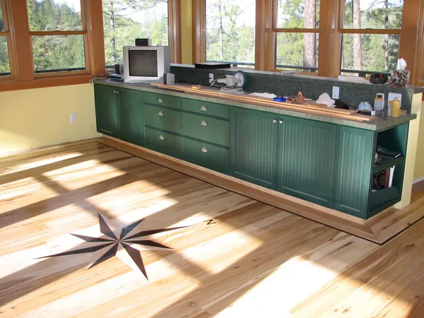 a tall yellow house with trees in front of it