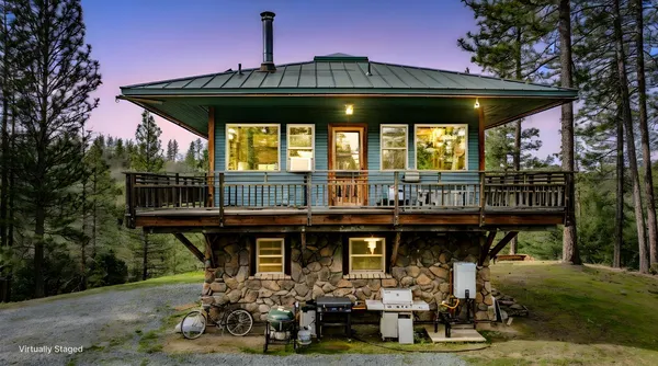 a front view of a house with balcony and deck