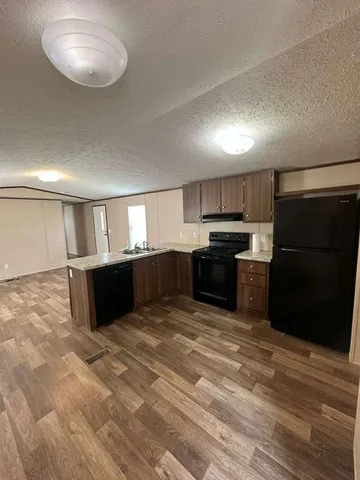 a view of a room with wooden floor