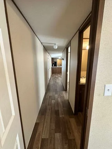 a bedroom with a bed and a flat tv screen on dresser