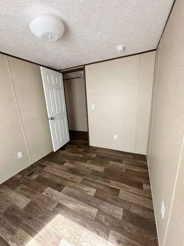 a bathroom with a granite countertop sink toilet a mirror and shower