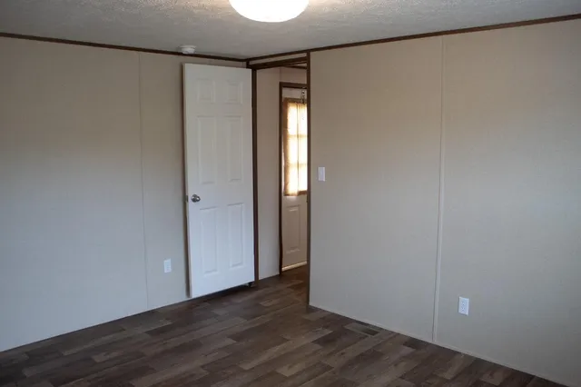 a bathroom with a granite countertop sink toilet and a mirror